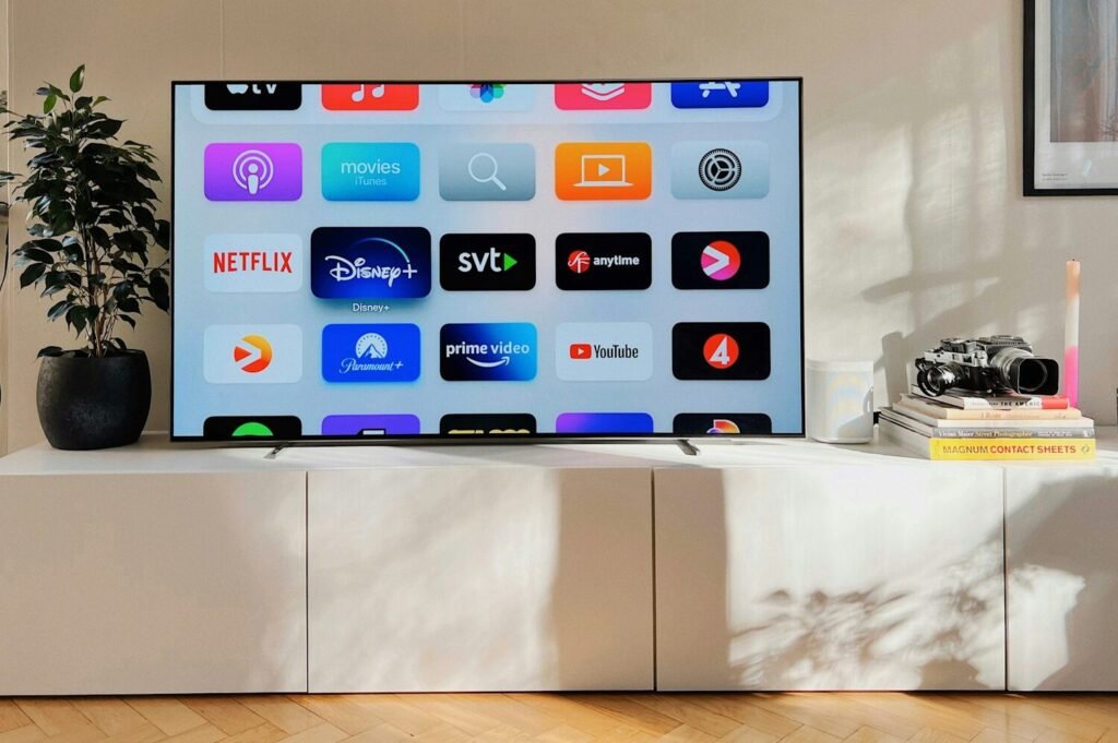 a flat screen tv sitting on top of a white cabinet